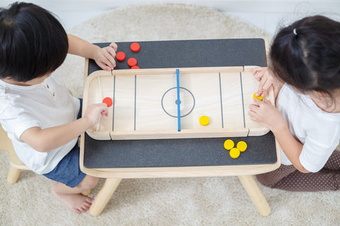 Kiddo Joy 2-In-1 Shuffleboard Game by PlanToys, an eco-friendly toy designed to promote strategic thinking, hand-eye coordination, and fine motor skills with a fun, versatile game for all ages.