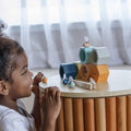 Kiddo Joy Beehives by PlanToys, an eco-friendly toy designed to enhance cognitive skills, problem-solving, and fine motor skills with fun, interactive beehive play pieces.