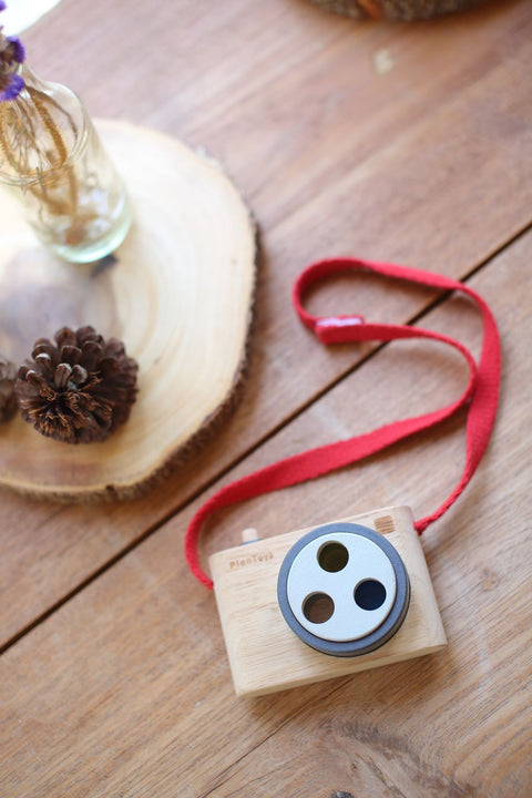 Kiddo Joy Colored Snap Camera by PlanToys, an eco-friendly toy designed to encourage imaginative play, enhance early photography skills, and foster creativity with vibrant, easy-to-use snap camera features.