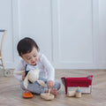 Kiddo Joy Doll Feeding Set by PlanToys, an eco-friendly toy designed to promote role play, nurturing skills, and empathy with realistic feeding accessories for imaginative play.