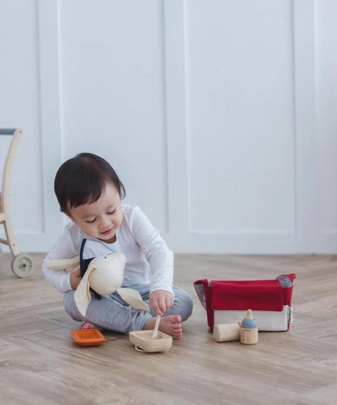 Kiddo Joy Doll Feeding Set by PlanToys, an eco-friendly toy designed to promote role play, nurturing skills, and empathy with realistic feeding accessories for imaginative play.