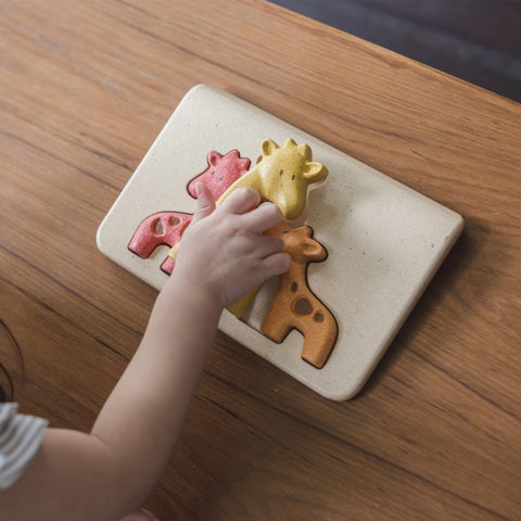 Kiddo Joy Giraffe Puzzle by PlanToys, an eco-friendly toy designed to enhance cognitive skills, problem-solving, and hand-eye coordination with fun, colorful giraffe-shaped pieces.