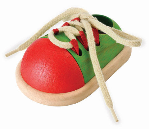 Kiddo Joy Tie-Up Shoe by PlanToys, an eco-friendly toy designed to enhance fine motor skills, hand-eye coordination, and independence through fun lacing and tying activities.